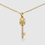 Stylish yellow gold skull key pendant with moissanite detail